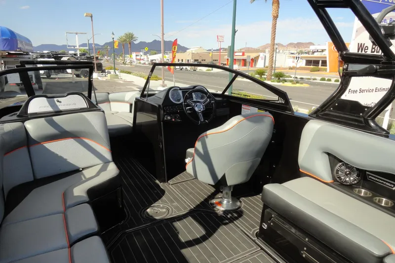 Slide: The Image of 2017 Moomba Craz boat interior with gray seating and modern dashboard. - 7