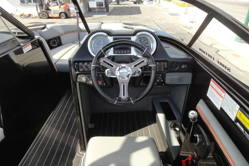Slide: The Image of 2017 Moomba Craz boat interior with steering wheel and dashboard controls. - 8