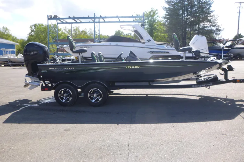 The Image of 2023 Ranger RT198P boat on trailer, parked outdoors with other boats in background. - 1