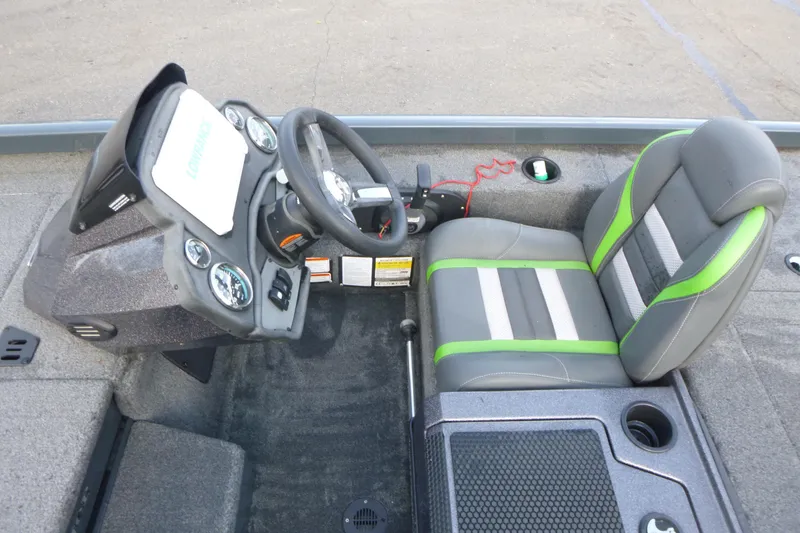 Slide: The Image of 2023 Ranger RT198P boat cockpit with steering wheel, gauges, and green-accented seat. - 10