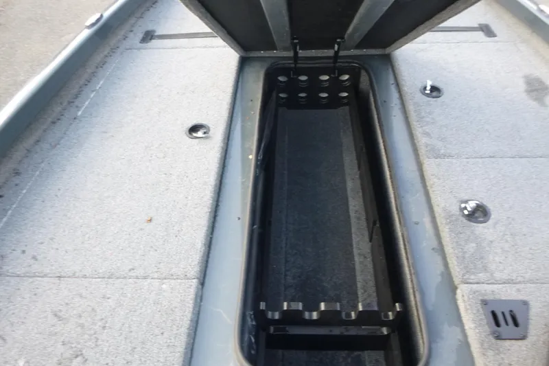 Slide: The Image of 2023 Ranger RT198P boat interior storage compartment with open lid, showcasing spacious design. - 12