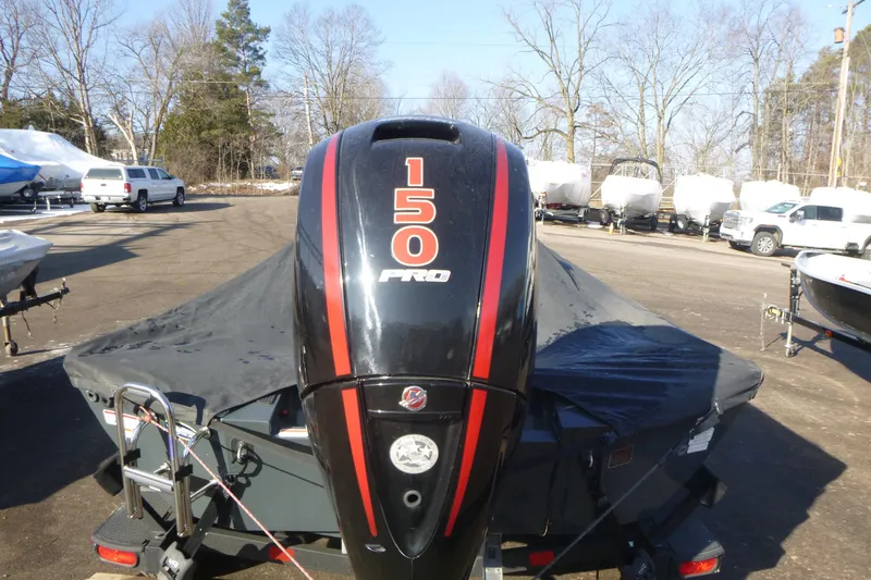 Slide: The Image of 2023 Ranger RT198P boat with 150 Pro engine, covered and parked outdoors. - 18