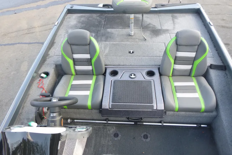 Slide: The Image of 2023 Ranger RT198P boat interior with gray and green seats, steering wheel, and storage console. - 9