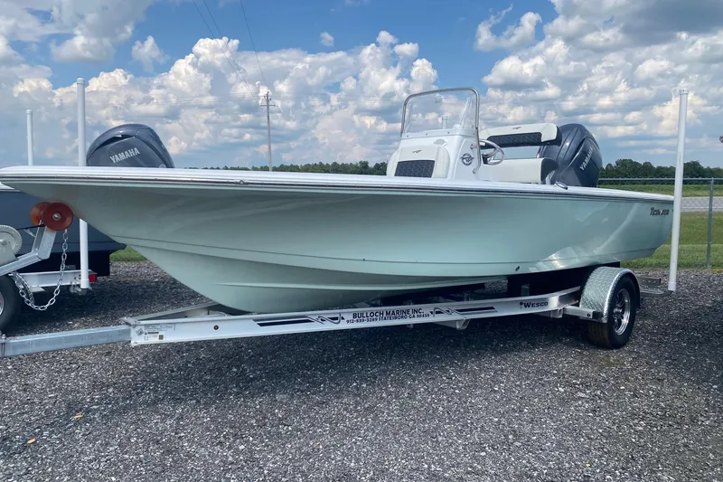 The Image of 2024 Tidewater 1910 Bay Max boat on trailer, parked outdoors under a cloudy sky. - 0