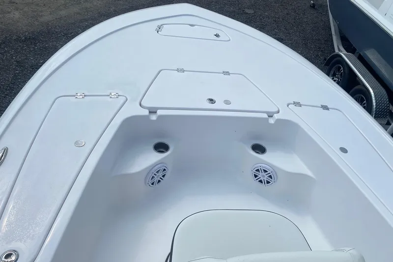 Slide: The Image of 2024 Tidewater 1910 Bay Max boat deck with storage compartments and speakers. - 2