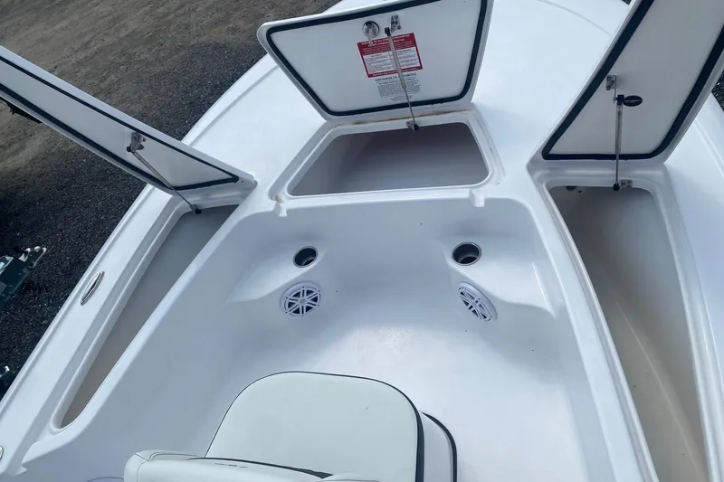Slide: The Image of 2024 Tidewater 1910 Bay Max boat interior with open storage compartments and speakers. - 3