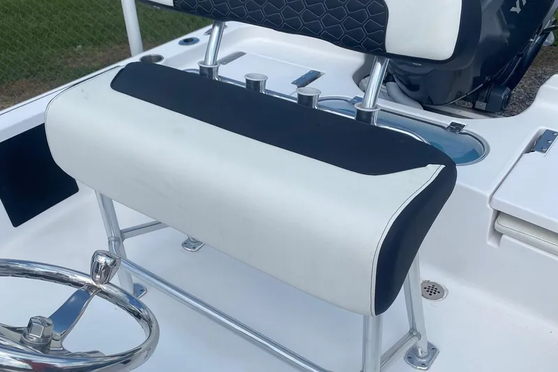 Slide: The Image of 2024 Tidewater 1910 Bay Max boat interior with cushioned seating and steering wheel. - 6