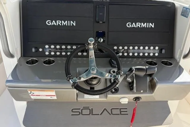 Slide: The Image of Helm of 2026 Solace 37 CS boat with Garmin displays and steering wheel. - 3