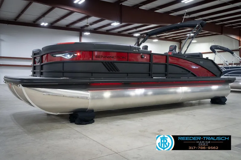Slide: The Image of 2026 Bennington 24 MSB pontoon boat in showroom, featuring sleek design and modern amenities. - 1