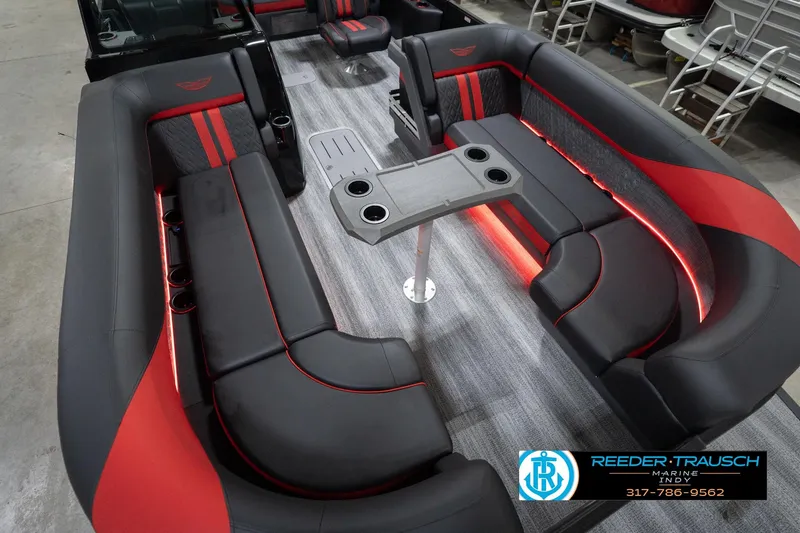 Slide: The Image of Luxurious interior of 2026 Bennington 24 MSB pontoon boat with red and black seating. - 11