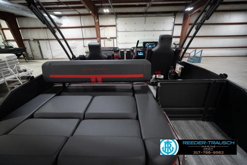 Slide: The Image of 2026 Bennington 24 MSB boat interior with seating and control panel in a showroom. - 17