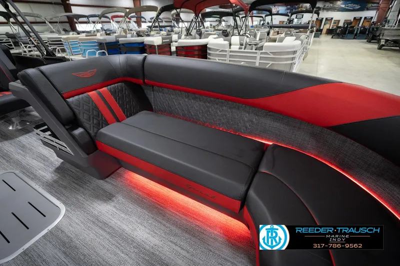 Slide: The Image of Luxurious interior of 2026 Bennington 24 MSB pontoon boat with red and black seating. - 21
