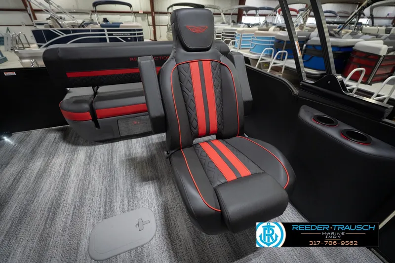 Slide: The Image of 2026 Bennington 24 MSB boat interior with red and black seating, cup holders, and carpeted flooring. - 28