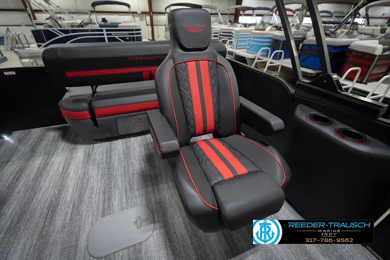 Slide: The Image of 2026 Bennington 24 MSB boat interior with red and black seating, cup holders, and carpeted flooring. - 29