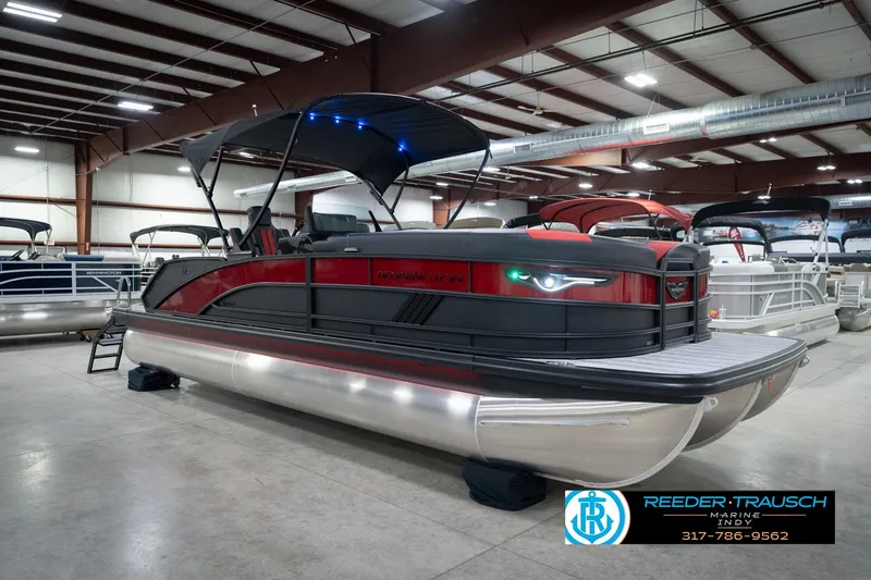 Slide: The Image of 2026 Bennington 24 MSB pontoon boat in showroom, featuring sleek design and modern amenities. - 4