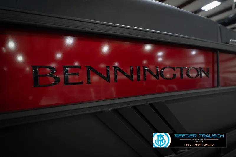 Slide: The Image of 2026 Bennington 24 MSB boat with red and black detailing, Reeder-Trausch Marine logo. - 52
