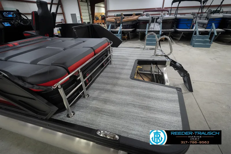 Slide: The Image of 2026 Bennington 24 MSB pontoon boat interior with seating and storage, displayed at Reeder-Trausch Marine. - 55