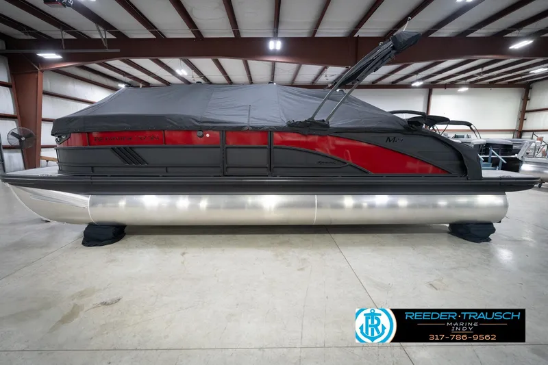 Slide: The Image of 2026 Bennington 24 MSB pontoon boat in indoor showroom, covered and ready for sale. - 56