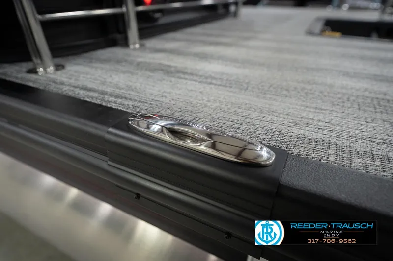 Slide: The Image of 2026 Bennington 24 MSB boat deck with sleek metal detailing, Reeder Trausch Marine logo. - 57