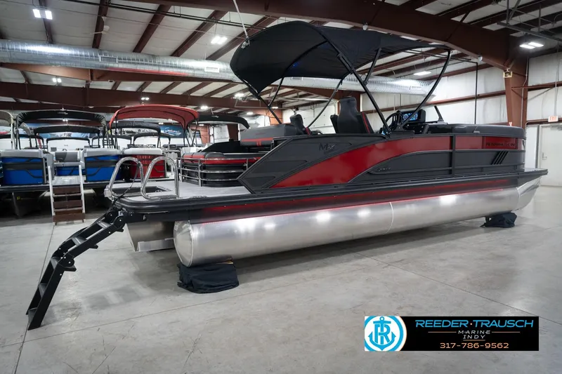 Slide: The Image of 2026 Bennington 24 MSB pontoon boat in showroom, featuring sleek design and modern amenities. - 6
