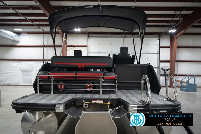 Slide: The Image of 2026 Bennington 24 MSB pontoon boat in a warehouse, featuring sleek design and modern amenities. - 7