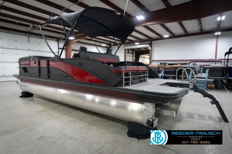 Slide: The Image of 2026 Bennington 24 MSB pontoon boat in showroom, featuring sleek design and canopy. - 8