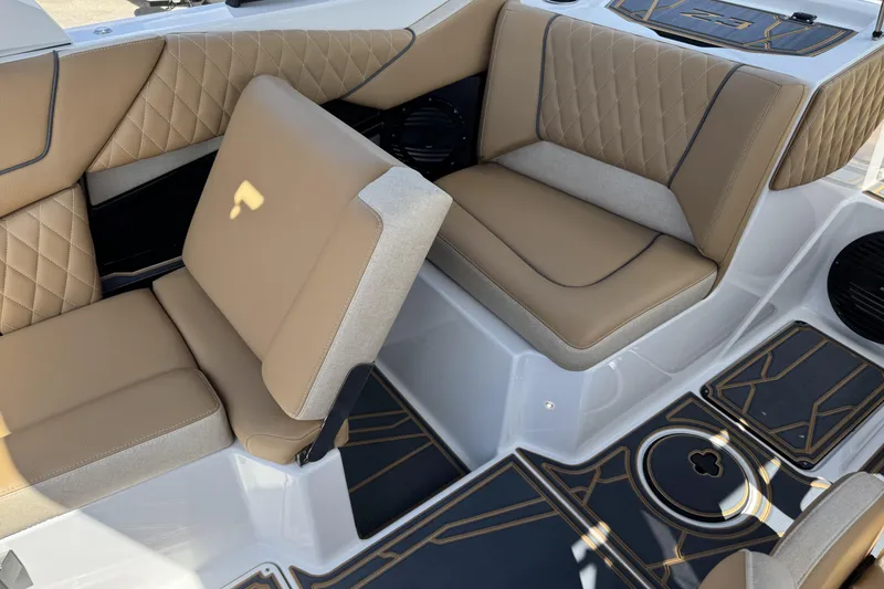 Slide: The Image of 2026 Tigé Z3 boat interior with tan quilted seats and stylish flooring design. - 11