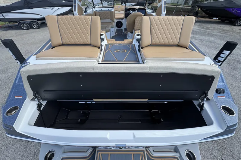Slide: The Image of 2026 Tigé Z3 boat with open storage compartment and tan seating. - 15