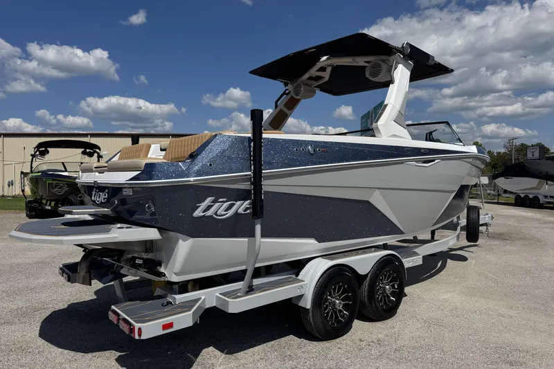 Slide: The Image of 2026 Tigé Z3 boat on trailer under blue sky with clouds. - 2