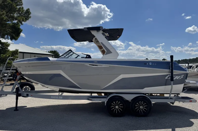 Slide: The Image of 2026 Tigé Z3 boat on trailer under blue sky with clouds. - 4