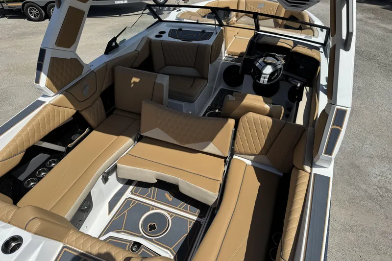 Slide: The Image of Luxurious interior of 2026 Tigé Z3 boat with tan leather seating and modern dashboard. - 9