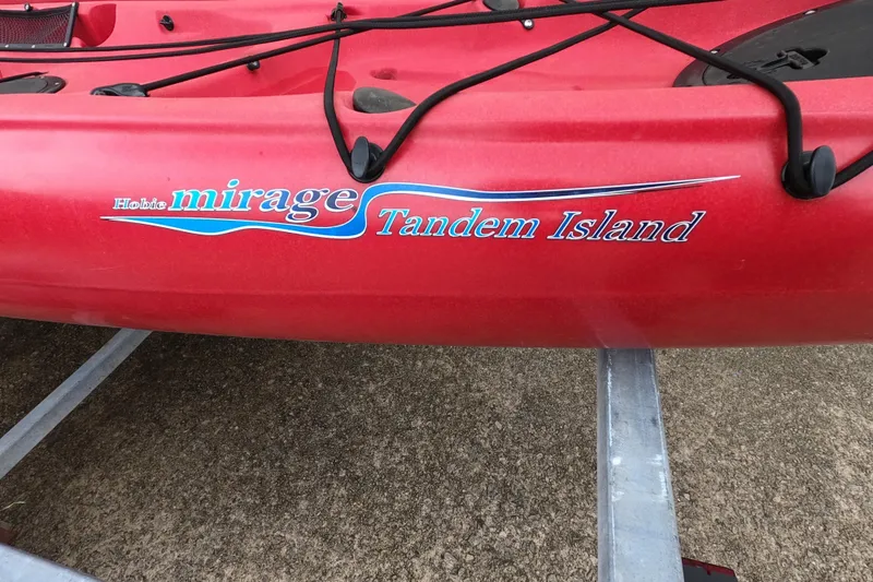 Slide: The Image of Red 2012 Hobie Mirage Tandem Island kayak with logo on side. - 4