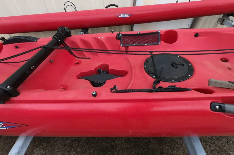 Slide: The Image of Red 2012 Hobie Mirage Tandem Island kayak with visible storage hatch and rigging. - 7