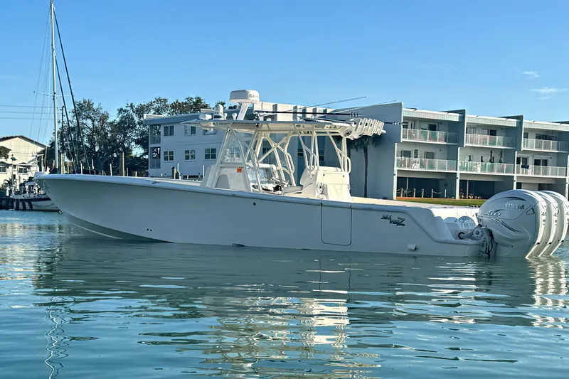 Slide: The Image of 2024 SeaVee 390Z boat on calm water, featuring triple Yamaha engines. - 18