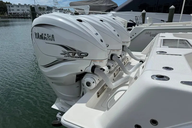 Slide: The Image of 2024 SeaVee 390Z boat with triple Yamaha XTO Offshore engines docked. - 2