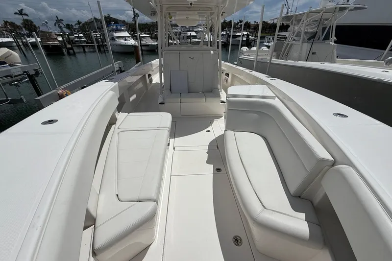 Slide: The Image of 2024 SeaVee 390Z boat interior with white seating, docked at marina. - 6