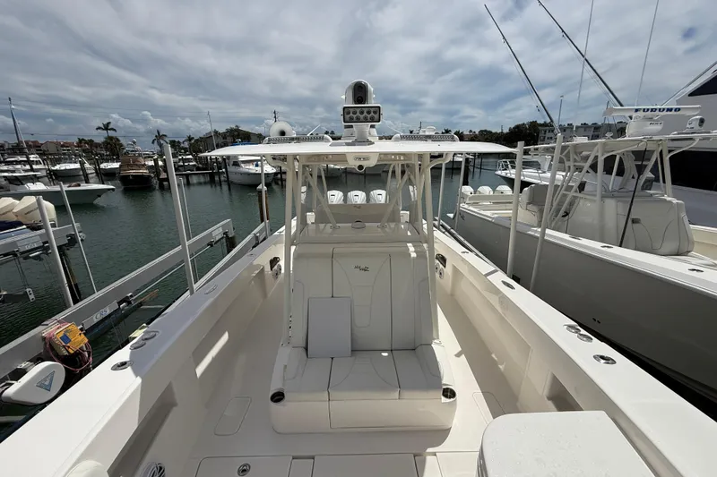 Slide: The Image of 2024 SeaVee 390Z boat docked at marina, showcasing spacious deck and seating area. - 9