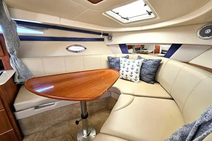 Slide: The Image of Interior of 2008 Bayliner 320 yacht with cozy seating and wooden table. - 12