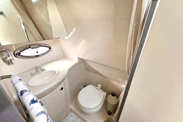 Slide: The Image of 2008 Bayliner 320 boat bathroom with sink, toilet, and mirror. - 22