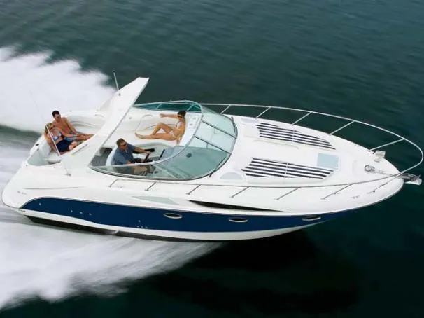 Slide: The Image of 2008 Bayliner 320 boat cruising on water with passengers enjoying the ride. - 24