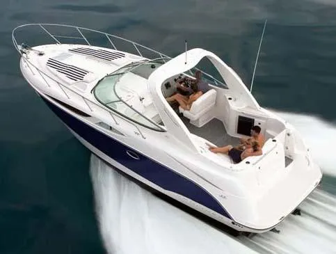 Slide: The Image of 2008 Bayliner 320 cruising on open water, featuring sleek design and spacious deck. - 25