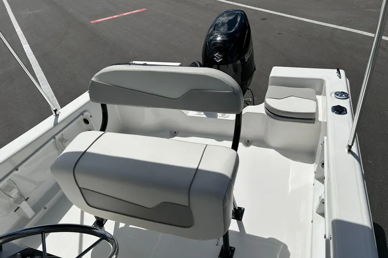 Slide: The Image of 2022 Key Largo 1800 Center Console boat interior with seating and outboard motor. - 11