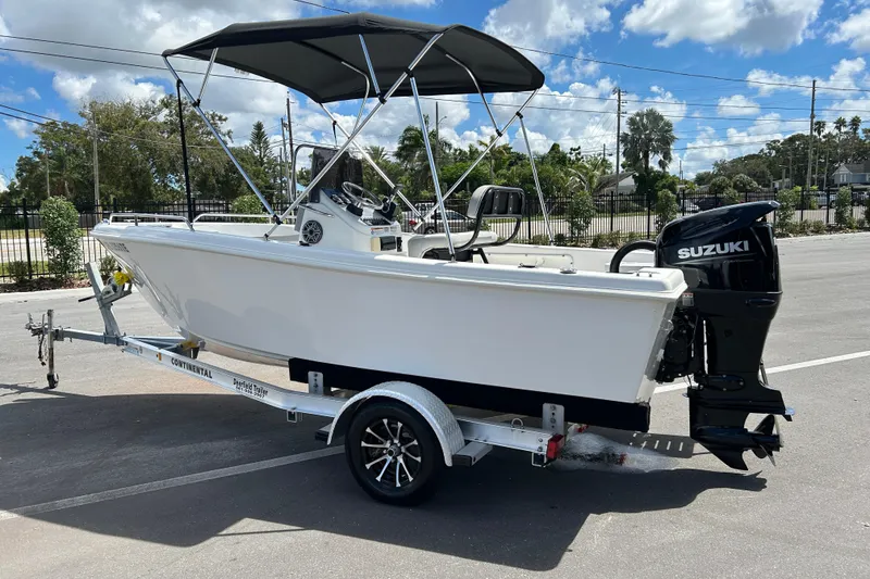 Slide: The Image of 2022 Key Largo 1800 Center Console boat with Suzuki outboard motor on trailer. - 4