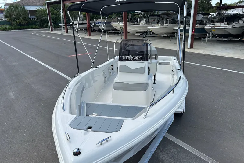 Slide: The Image of 2022 Key Largo 1800 Center Console boat on trailer, parked in marina. - 6