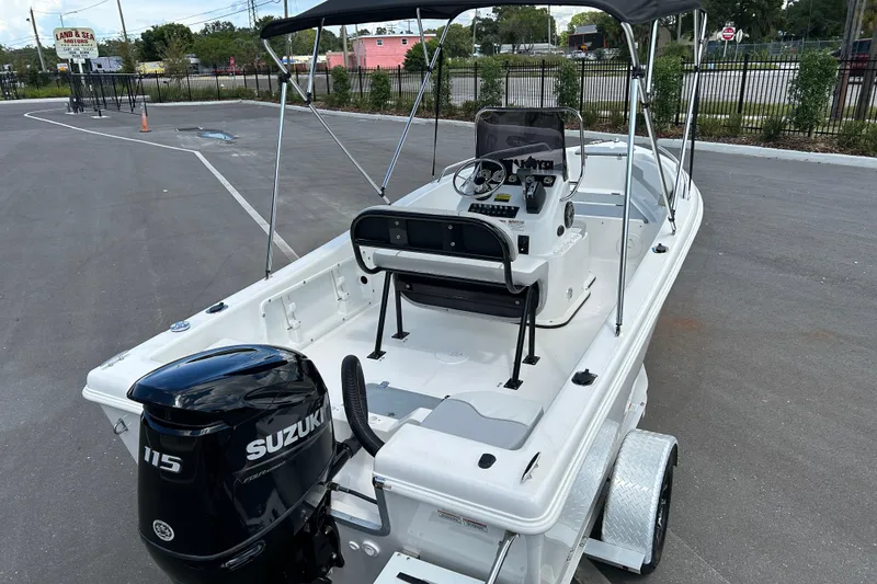 Slide: The Image of 2022 Key Largo 1800 Center Console boat with Suzuki 115 engine, parked outdoors. - 7