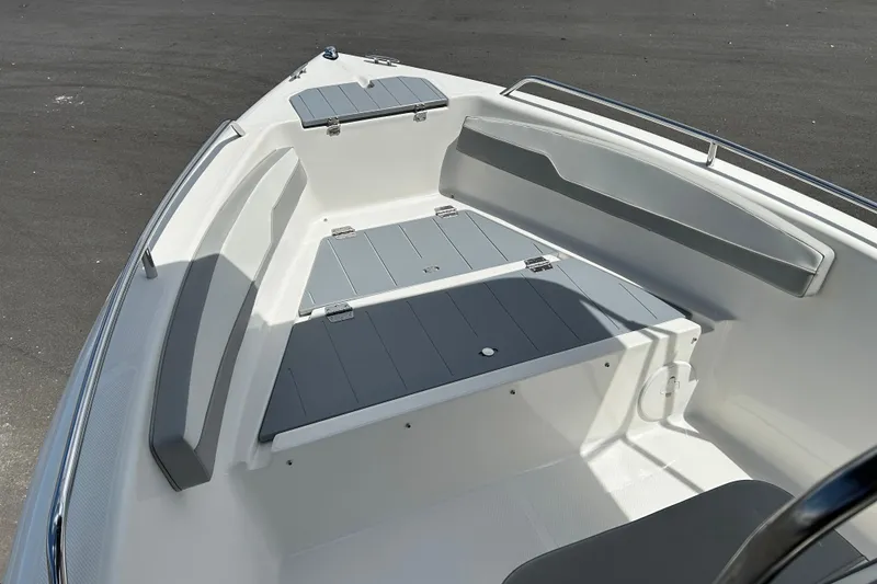Slide: The Image of 2022 Key Largo 1800 Center Console boat interior with gray seating and storage. - 8
