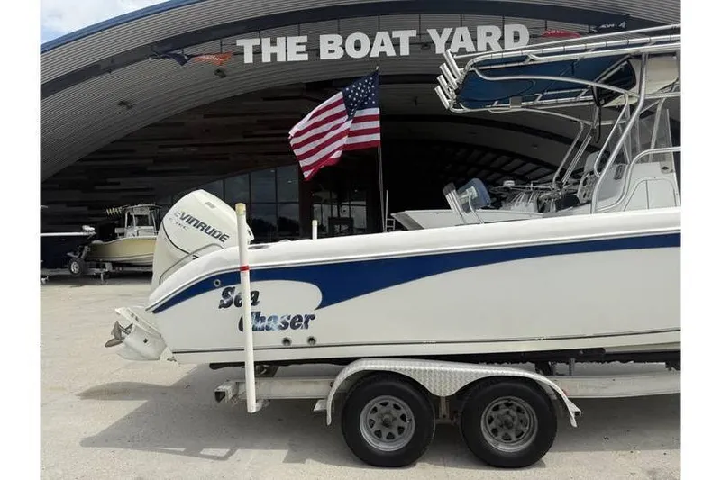 Slide: The Image of 2008 Sea Chaser 2400 CC boat on trailer at The Boat Yard with American flag. - 3