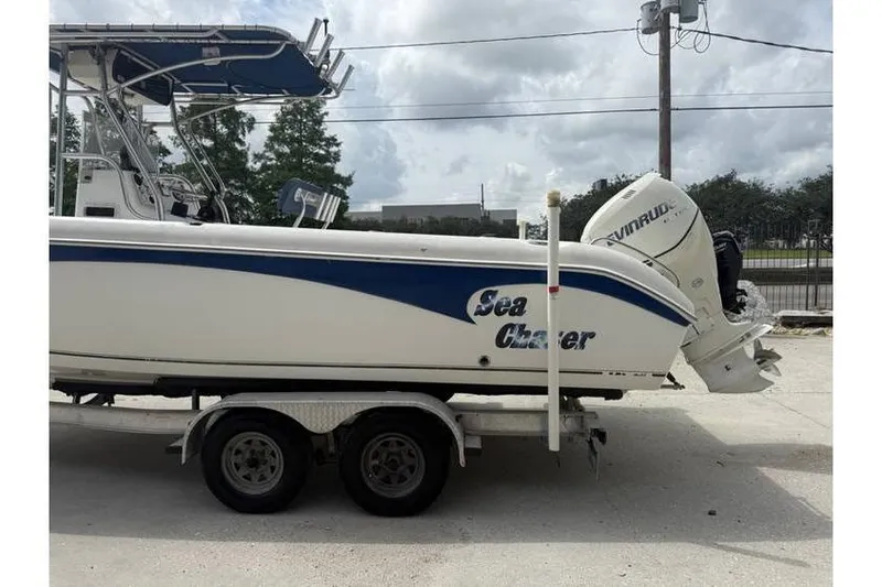 Slide: The Image of 2008 Sea Chaser 2400 CC boat on trailer with Evinrude outboard motor. - 4