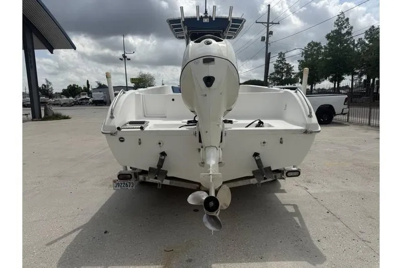 Slide: The Image of 2008 Sea Chaser 2400 CC boat, rear view with outboard motor, parked outdoors. - 5
