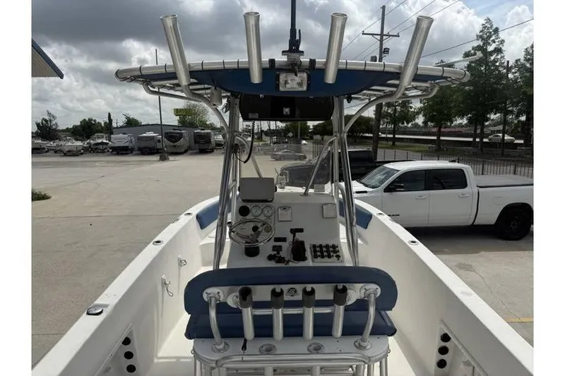 Slide: The Image of 2008 Sea Chaser 2400 CC boat with center console and rod holders in a parking lot. - 6